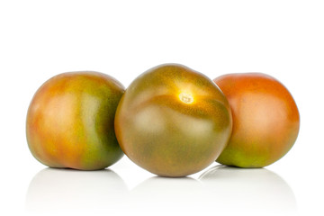 Group of three whole shiny fresh greenish red tomato isolated on white background