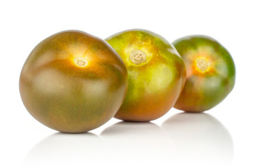 Group of three whole fresh greenish red tomato in row isolated on white background