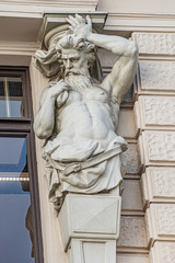 Statue of powerful and emotional atlas of Renaissance Era as support for building facade in Vienna,...