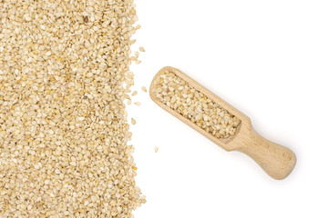 Lot of whole unpeeled sesame seeds with wooden scoop flatlay isolated on white background