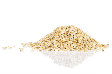 Lot of whole unpeeled sesame seeds isolated on white background