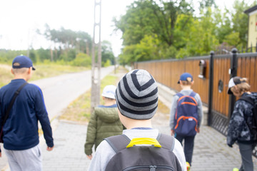 children going to school with backpacks