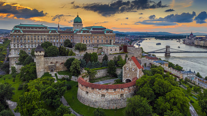 Fototapeta na wymiar Budapest, Hungary - Aerial view of the famous Buda Castle Royal Palace with Szechenyi Chain Bridge and Hungarian Parliament building at sunset time with colorful sky