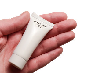 A tube of contact gel in the palm of hand. Isolated on white background.