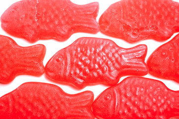 Isolated red fish-shaped jelly. Jellyfisk with strawberry flavor. Typical norwegian and swedish sweets called Jordbærfisker.