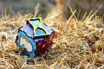 A wooden game for children, developing logical in the form of a cube on a thatched surface for...