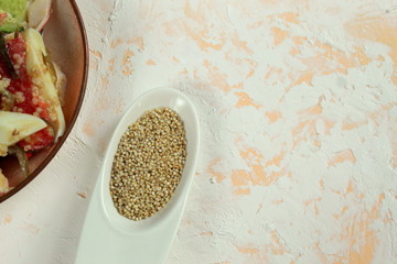 quinoa in a white small bowl for cooking the right food.