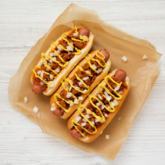 Homemade Detroit style chili dog on a white wooden background, top view. From above, overhead, flat...