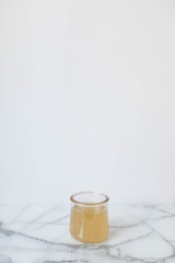 Glass of Kombucha, Healthy Probiotic Drink, White and Marble Background, Copy Space