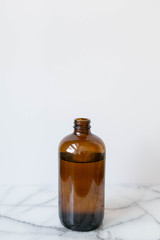 Amber Glass of Kombucha, Water Jug, Healthy Probiotic Drink, White and Marble Background, Copy Space