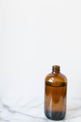 Amber Glass of Kombucha, Water Jug, Healthy Probiotic Drink, White and Marble Background, Copy Space