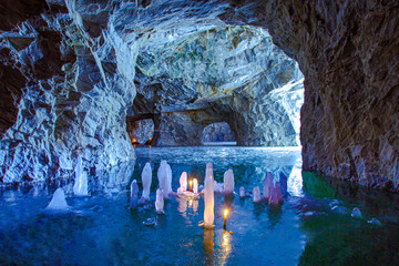 Karelia. Ruskeala. Marble cave. Ice stalactites and stalagmites. nature of Russia. In a cave burning candles. Icicles. Travelling to Karelia