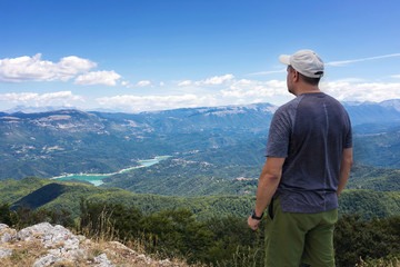 Fototapeta na wymiar Mountain explorer observes the landscape on the horizon