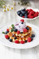 waffles with blueberries and raspberries and berry ice cream from yogurt.