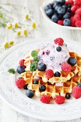 waffles with blueberries and raspberries and berry ice cream from yogurt.