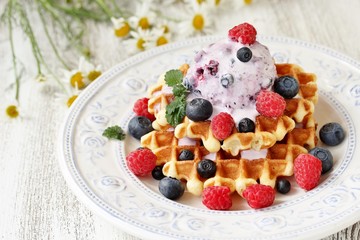 waffles with blueberries and raspberries and berry ice cream from yogurt.
