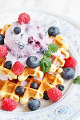 waffles with blueberries and raspberries and berry ice cream from yogurt.