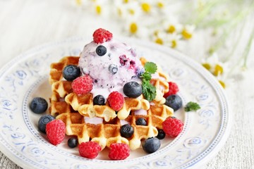 waffles with blueberries and raspberries and berry ice cream from yogurt.