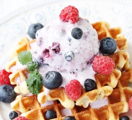 waffles with blueberries and raspberries and berry ice cream from yogurt.