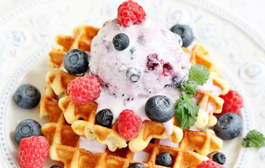 waffles with blueberries and raspberries and berry ice cream from yogurt.