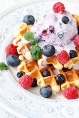 waffles with blueberries and raspberries and berry ice cream from yogurt.
