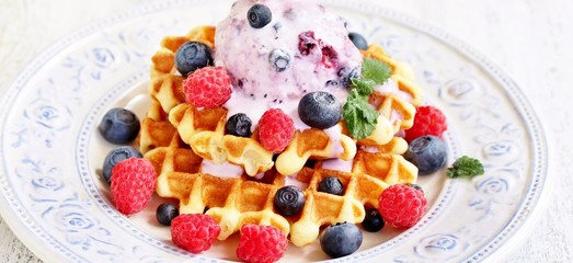 waffles with blueberries and raspberries and berry ice cream from yogurt.