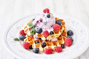 waffles with blueberries and raspberries and berry ice cream from yogurt.