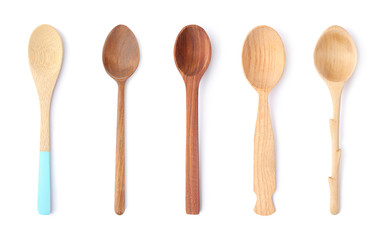 Set of different wooden spoons on white background, top view