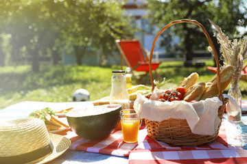 Picnic basket  and delicious food in park on sunny day