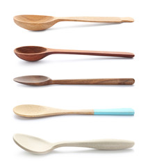 Set of different spoons on white background