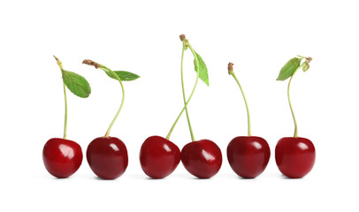 Row of delicious ripe sweet cherries on white background