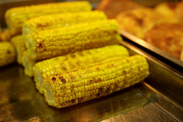 Delicious grilled corn cobs on table. Street food