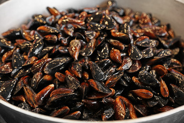Many delicious fresh mussels in pan, closeup