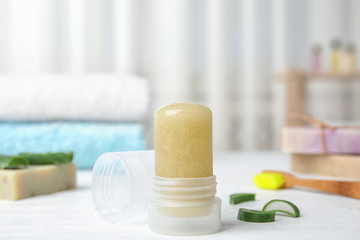 Natural crystal alum deodorant and aloe on white wooden table