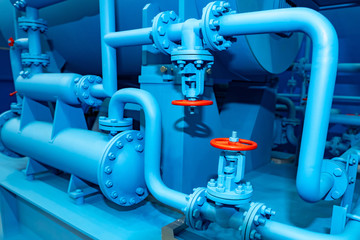 Blue pipes with red valves. Industrial equipment. Red valves on the pipes. Fuel production. Pipes...