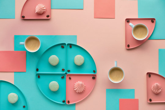 Geometric paper background in mint and coral colors with coffee and sweets
