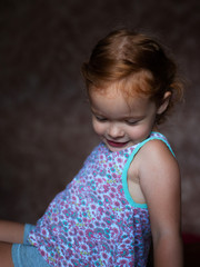 Naklejka premium shy little ginger girl embarrassed portrait
