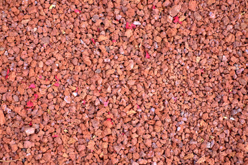 Red and orange volcanic gravel material.