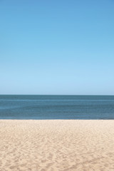 Fototapeta na wymiar Sandy beach near sea on sunny summer day