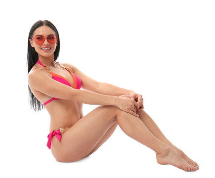 Beautiful young woman in stylish bikini with sunglasses on white background