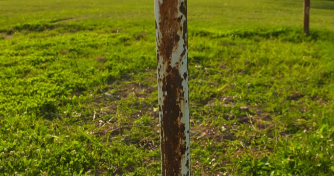 Pan up along the rusted poles of an old soccer goalpost