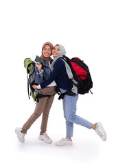 happy muslim two hijab woman carrying bagpack with isolated background