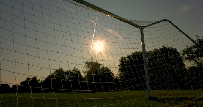 Looking at the sun through a soccer net at dawn