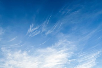 Dramatic unusual radiation explosion shaped clouds on tropical summer blue sky background. White wispy fluffy cloud with circus formation on tropical summer island sky in early sunlight morning 