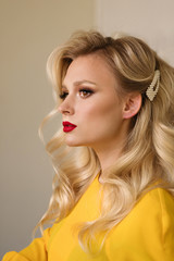 Side view closeup portrait of woman with creative elegant blondes hairstyle. Medium length wave...
