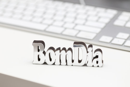 "Bom Dia" - Good Morning Letters Message Above a Minimalist Desk.