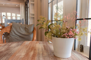 flower vase on wooden table in coffeehouse