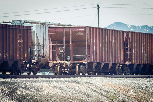 Classic Grain Hopper Train Cars on Tracks