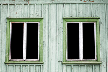 Vintage rustic wooden window frame. Black empty copy space inside. Old peeling paint cottage house wall.