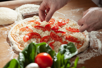  Male chef makes delicious juicy pizza. Close-up.